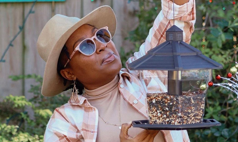 woman hanging feeder