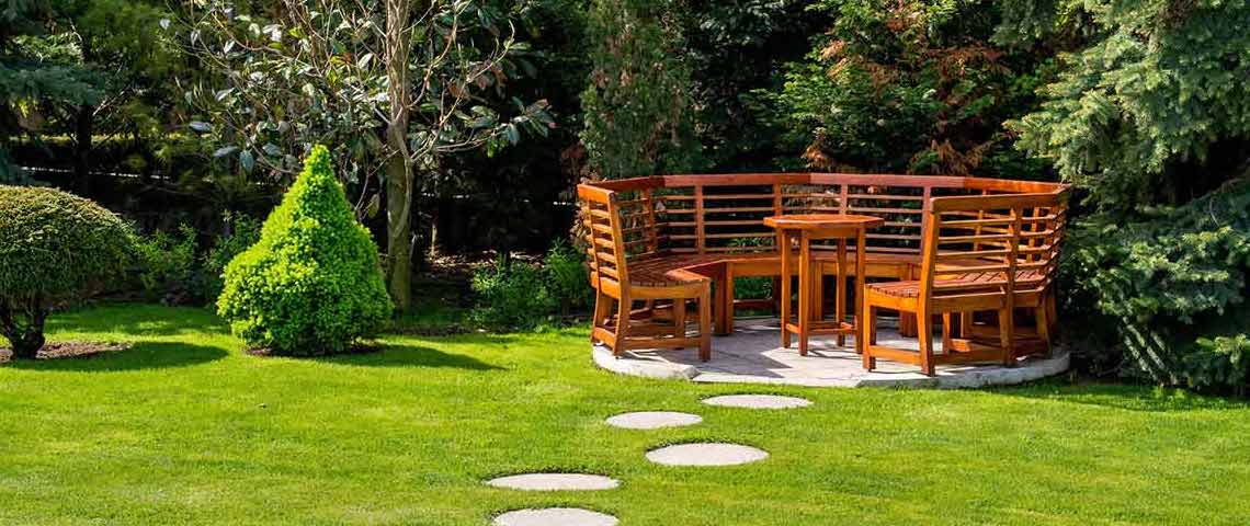 Spring garden with wooden seats and table